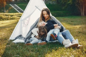 Mother with children playing in a summer park