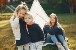 Mother with children playing in a summer park